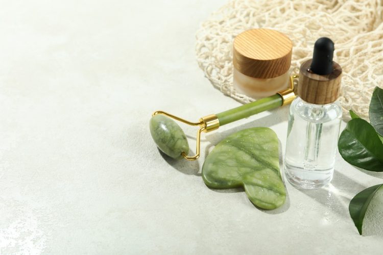 Face care concept with gua sha, face roller and cosmetic